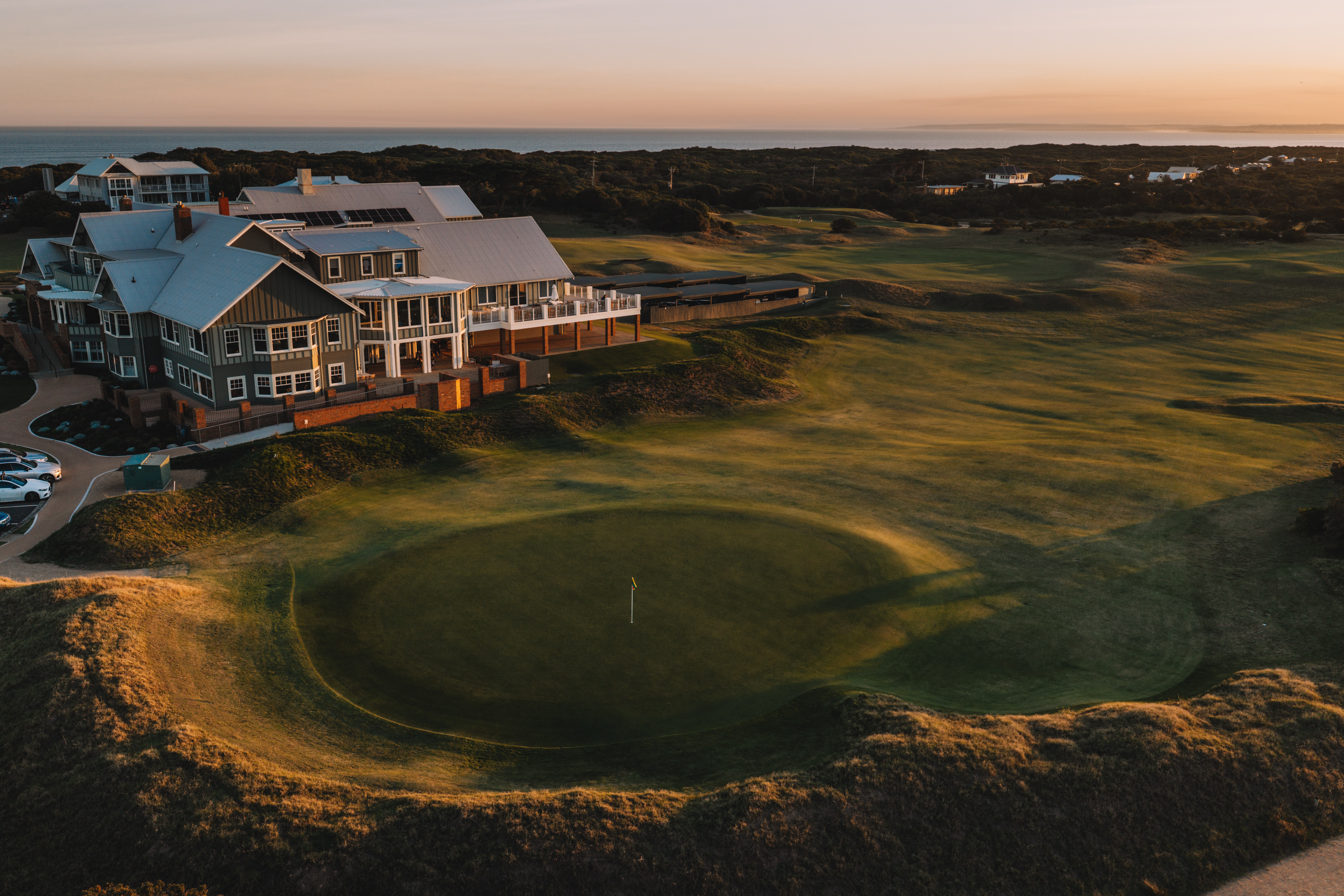 The Barwon Heads clubhouse above the eighteenth green in evening light